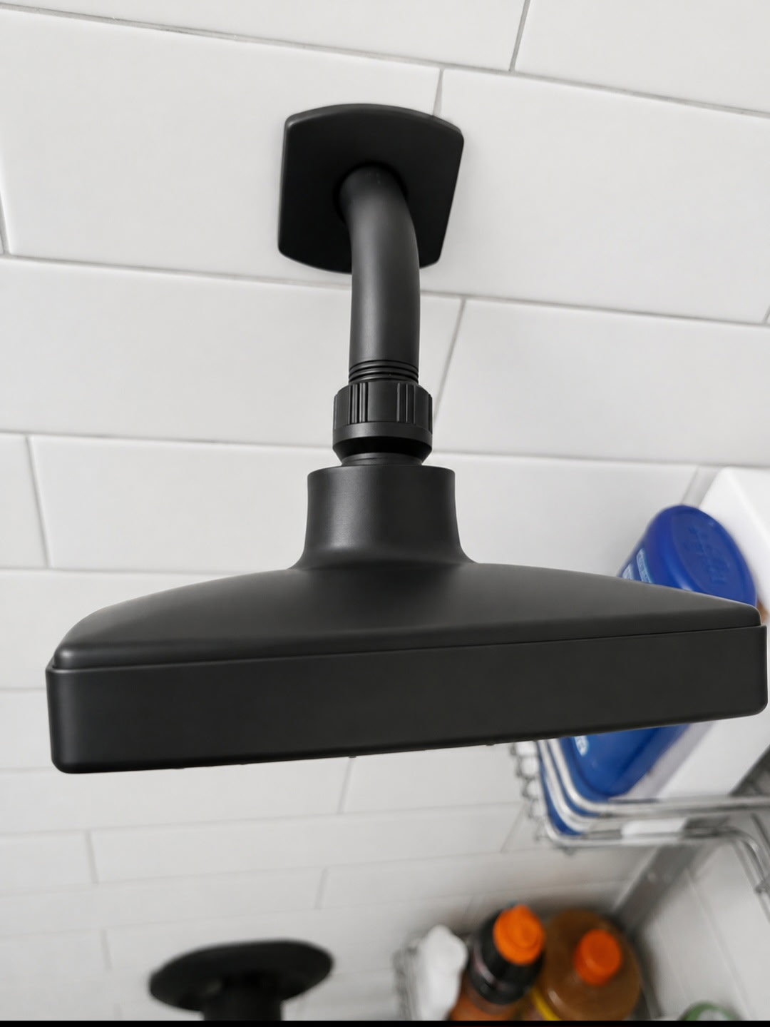 Restored matte black rain shower head free of mineral scale and spots after professional detail cleaning
